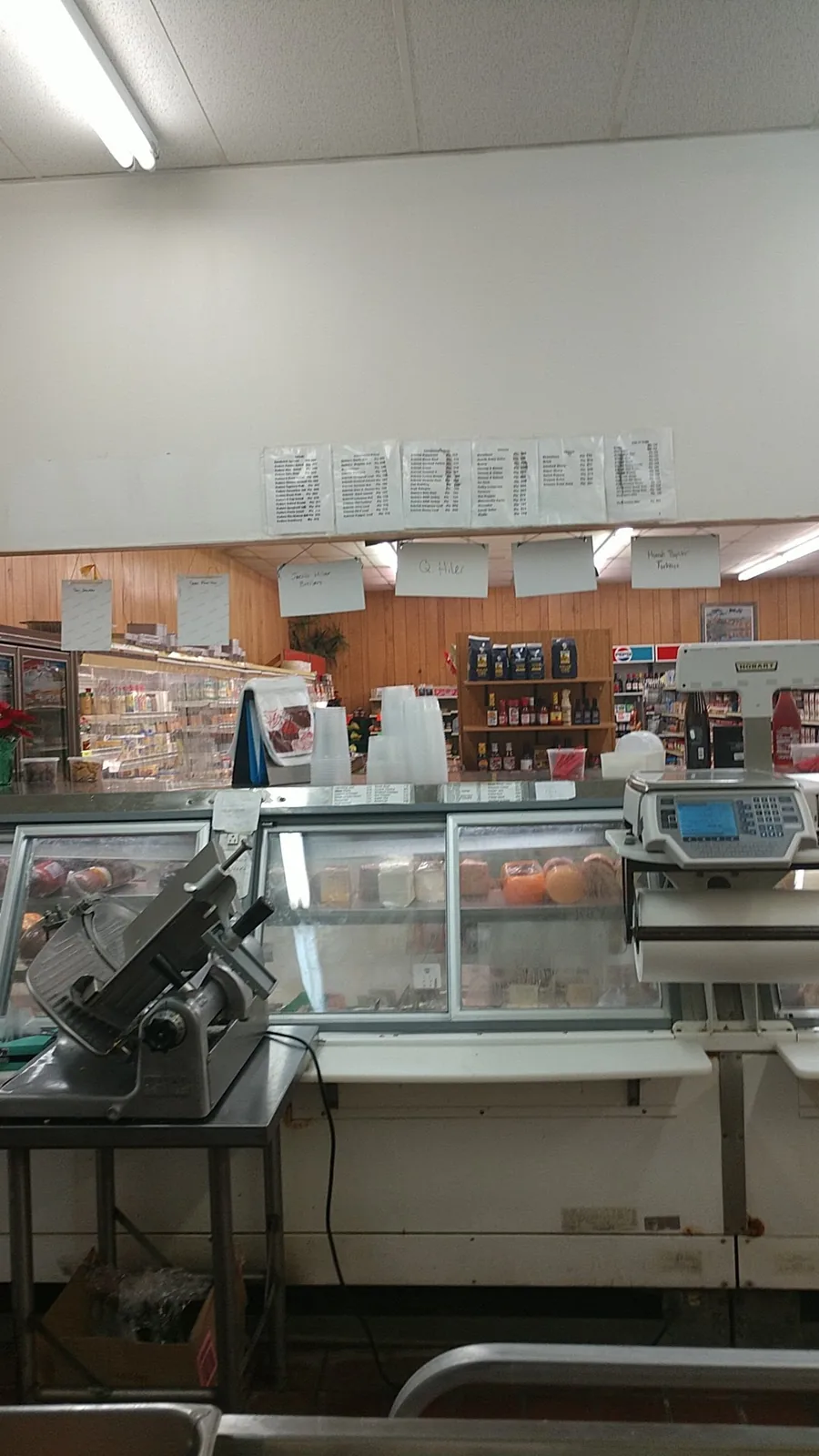 The refrigerated meat counter and shop interior at Gwirtz Foods